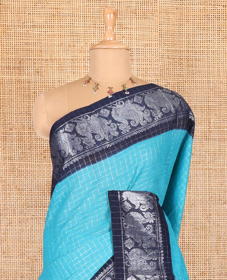 Blue checked sungudi cotton saree, contrast silver zari peacock motif border, striped pallu, and a contrast checked blouse