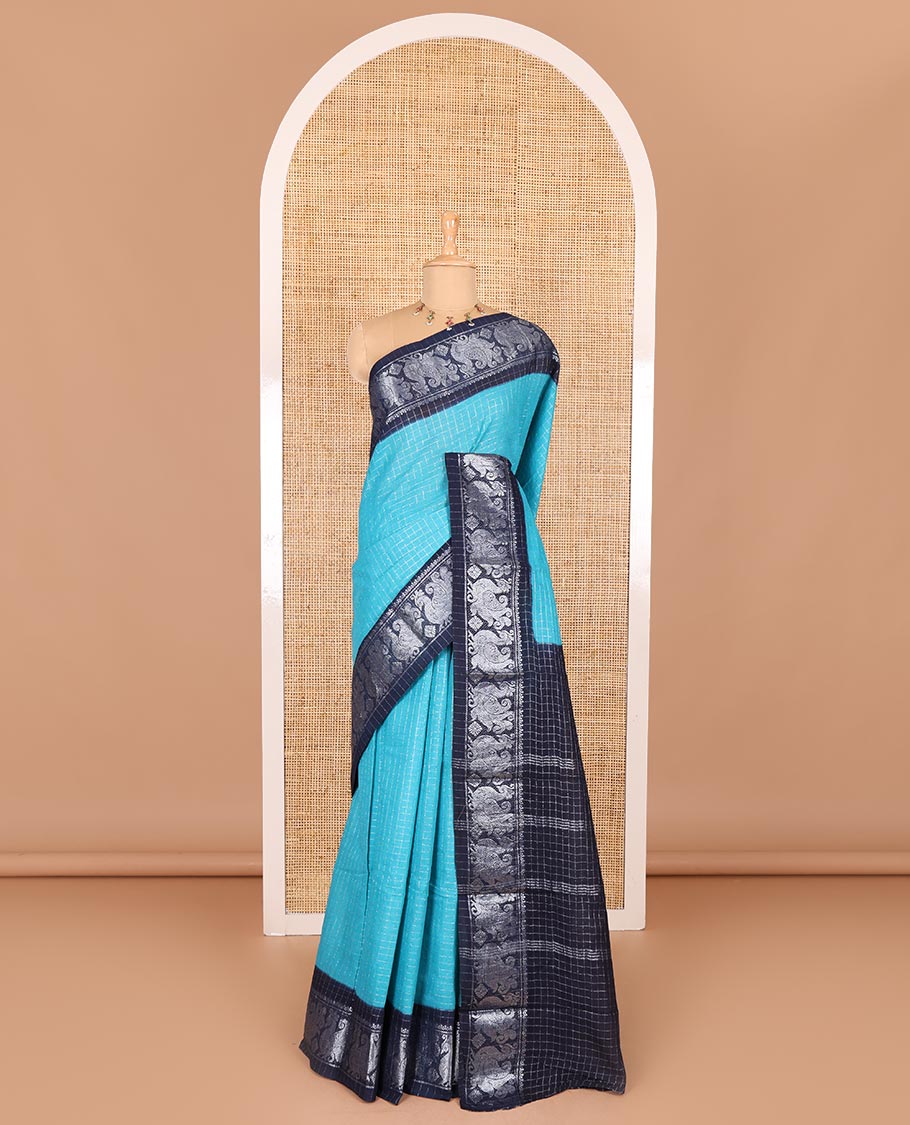 Blue checked sungudi cotton saree, contrast silver zari peacock motif border, striped pallu, and a contrast checked blouse