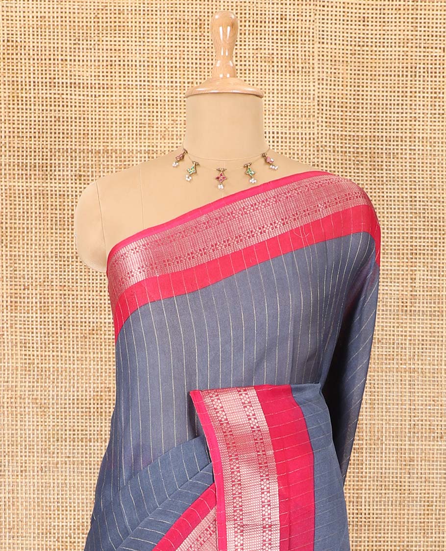 Grey vertically striped moss chiffon saree with contrast traditional zari design borders, striped pallu, and a contrast blouse