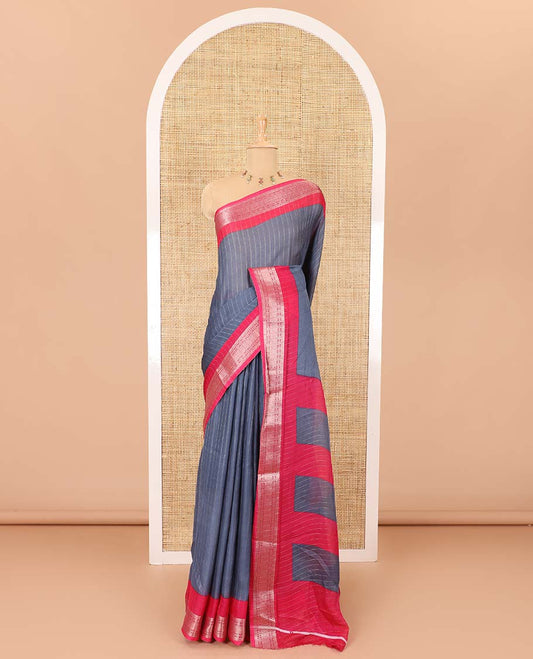 Grey vertically striped moss chiffon saree with contrast traditional zari design borders, striped pallu, and a contrast blouse