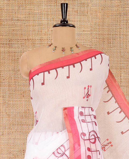 White and pink musical note motifs printed Chanderi cotton saree, zari piping border, geometric printed pallu, and a unique motifs printed blouse