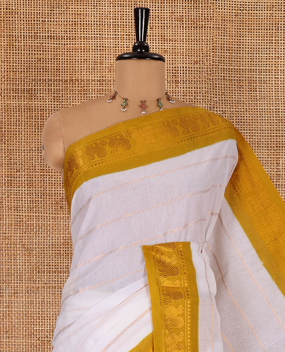 Half-white and yellow Veldhari striped Sungudi cotton saree, contrast traditional border of peacock buttas, zari striped pallu, and a contrast blouse