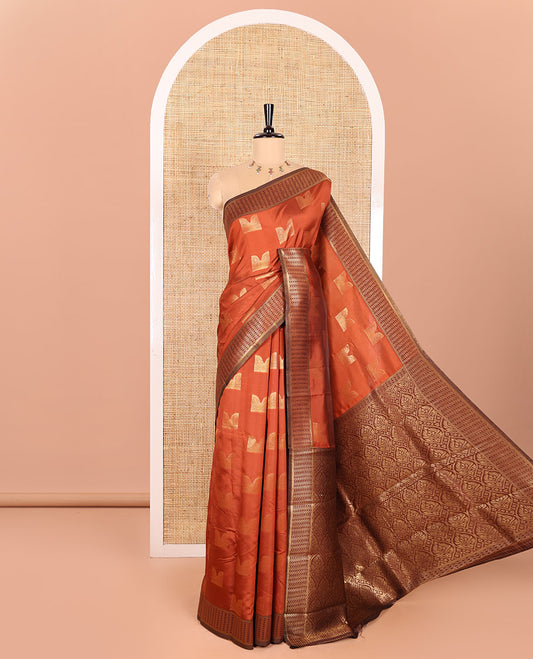 Rust Orange Kanchi Silk Saree Adorned with Zari Buttas All Over Its Body, Complemented by a Contrast Geometric-Patterned Border, Grand Pallu with Intricate Ogee Patterns, and Paired with a Contrast Blouse
