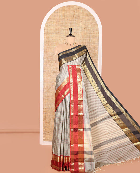Grey Semi-Soft Silk Saree Accentuated with Micro-Checks on Its Body, Complemented by a Contrast Rettai Pettu Zari Border of Paisley, and Chakram Designs, Subtly Striped Pallu, and Paired with a Contrast Blouse