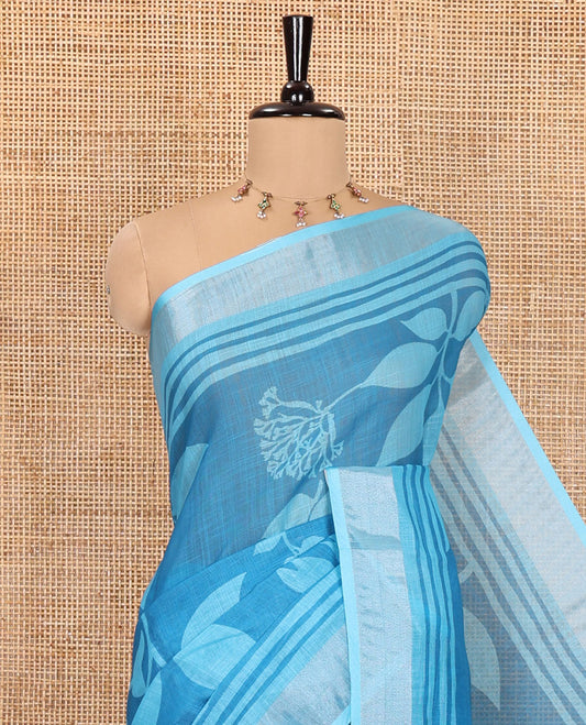 Blue Linen Cotton Saree, Beautified with Floral Leaf Motifs Printed on Its Body, Subtle Bavanji Border, Pallu Features Floral Print and Stripes, and Paired with a Matching Blouse