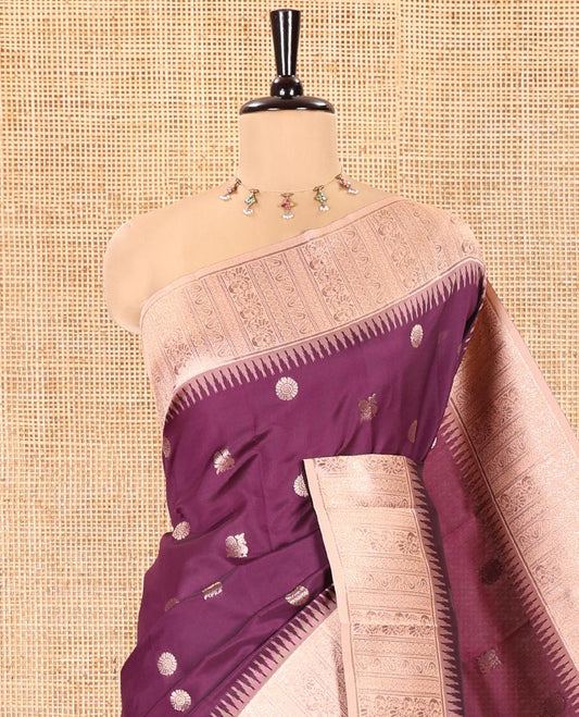Wine Kanchi Silk Saree, Elevated with Peacock-Chakram Buttas All Over Its Body, Complemented by a Contrast Border of Floral Creeper Designs, an Intricately Designed Pallu, and Paired with a Matching Blouse