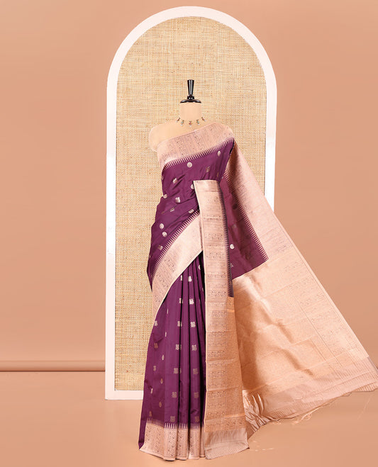 Wine Kanchi Silk Saree, Elevated with Peacock-Chakram Buttas All Over Its Body, Complemented by a Contrast Border of Floral Creeper Designs, an Intricately Designed Pallu, and Paired with a Matching Blouse