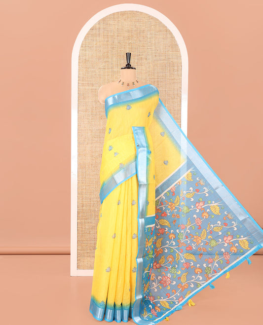 Yellow Linen Cotton Saree, Prettified with Floral Motifs Printed On Its Body, Complemented by Captivating Contrast Bavanji Border, Colorful Floral Vine Printed Pallu, and Paired with a Contrast Blouse