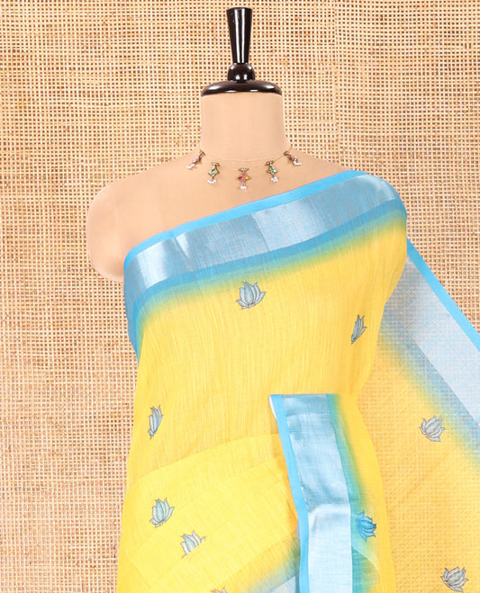 Yellow Linen Cotton Saree, Prettified with Floral Motifs Printed On Its Body, Complemented by Captivating Contrast Bavanji Border, Colorful Floral Vine Printed Pallu, and Paired with a Contrast Blouse