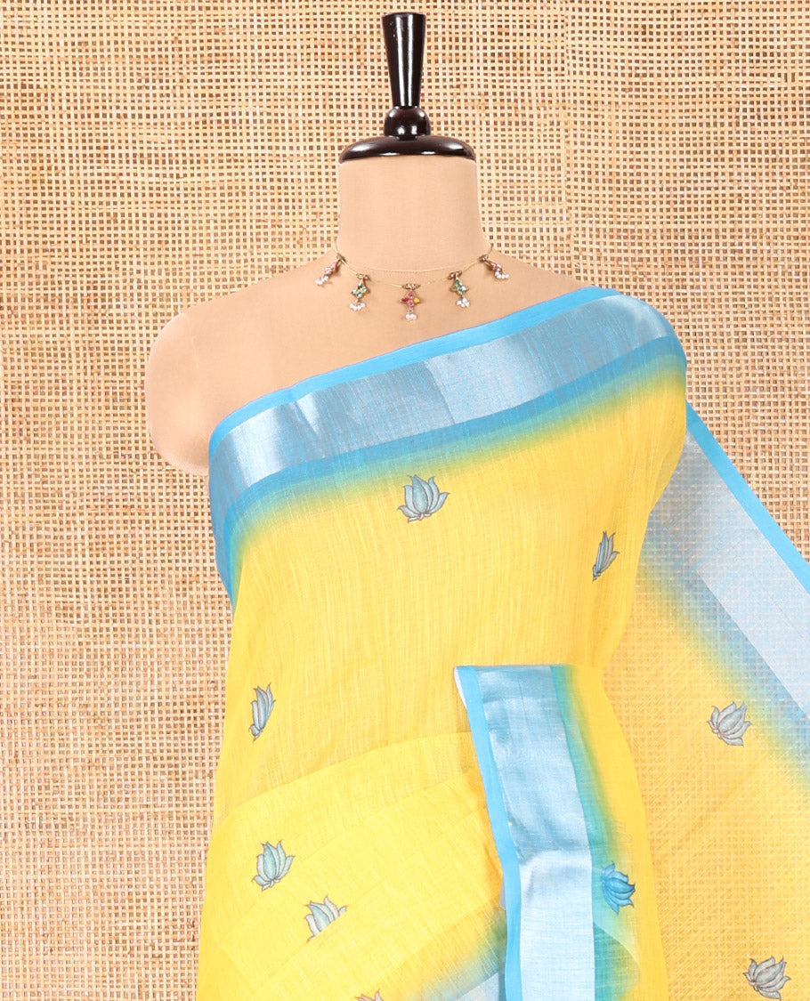 Yellow Linen Cotton Saree, Prettified with Floral Motifs Printed On Its Body, Complemented by Captivating Contrast Bavanji Border, Colorful Floral Vine Printed Pallu, and Paired with a Contrast Blouse