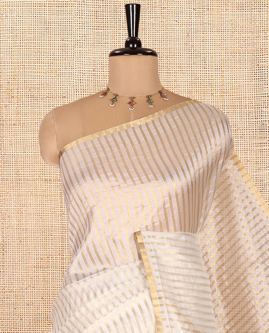 Borderless Off-white Tissue Saree, Richly Detailed with Vertical Golden Zari Stripes All Over Its Body, Highlighted by Gleaming Zari Striped Pallu, and Paired with a Matching Blouse