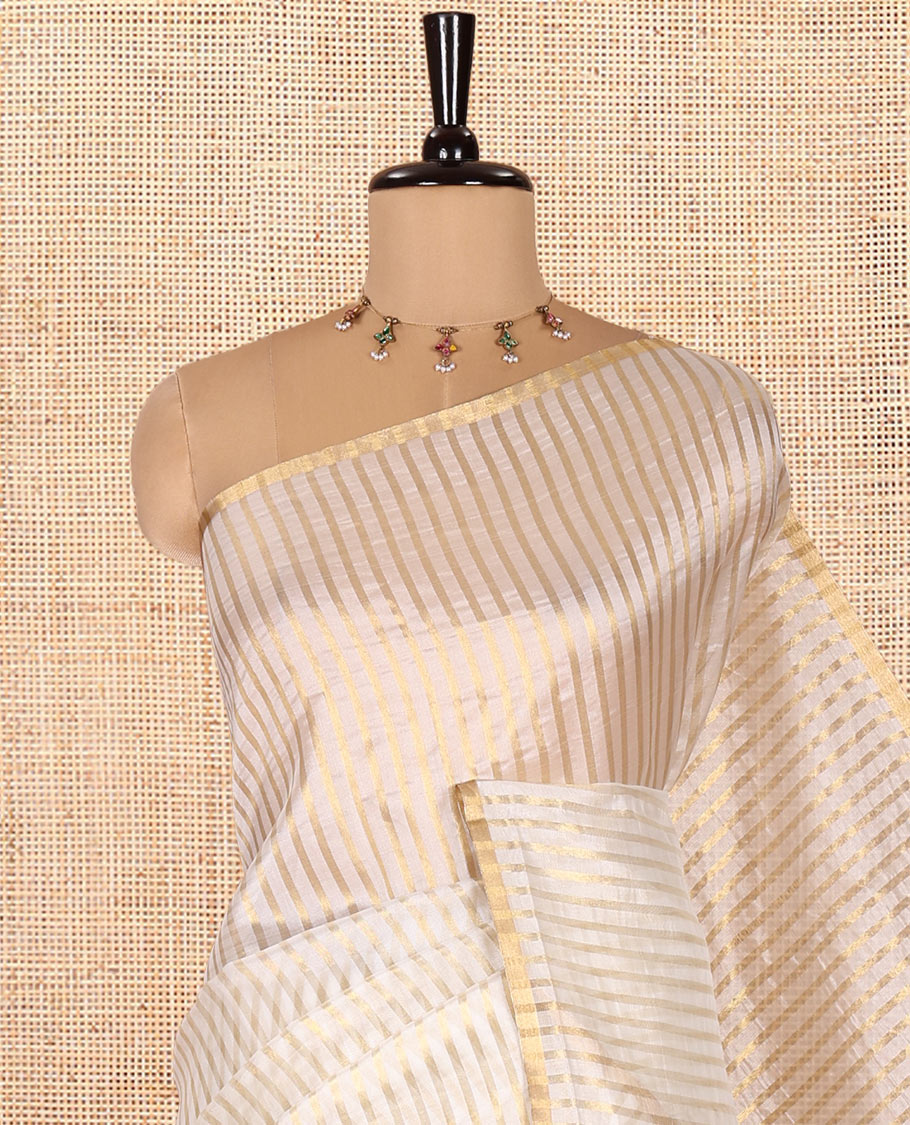 Borderless Off-white Tissue Saree, Richly Detailed with Vertical Golden Zari Stripes All Over Its Body, Highlighted by Gleaming Zari Striped Pallu, and Paired with a Matching Blouse