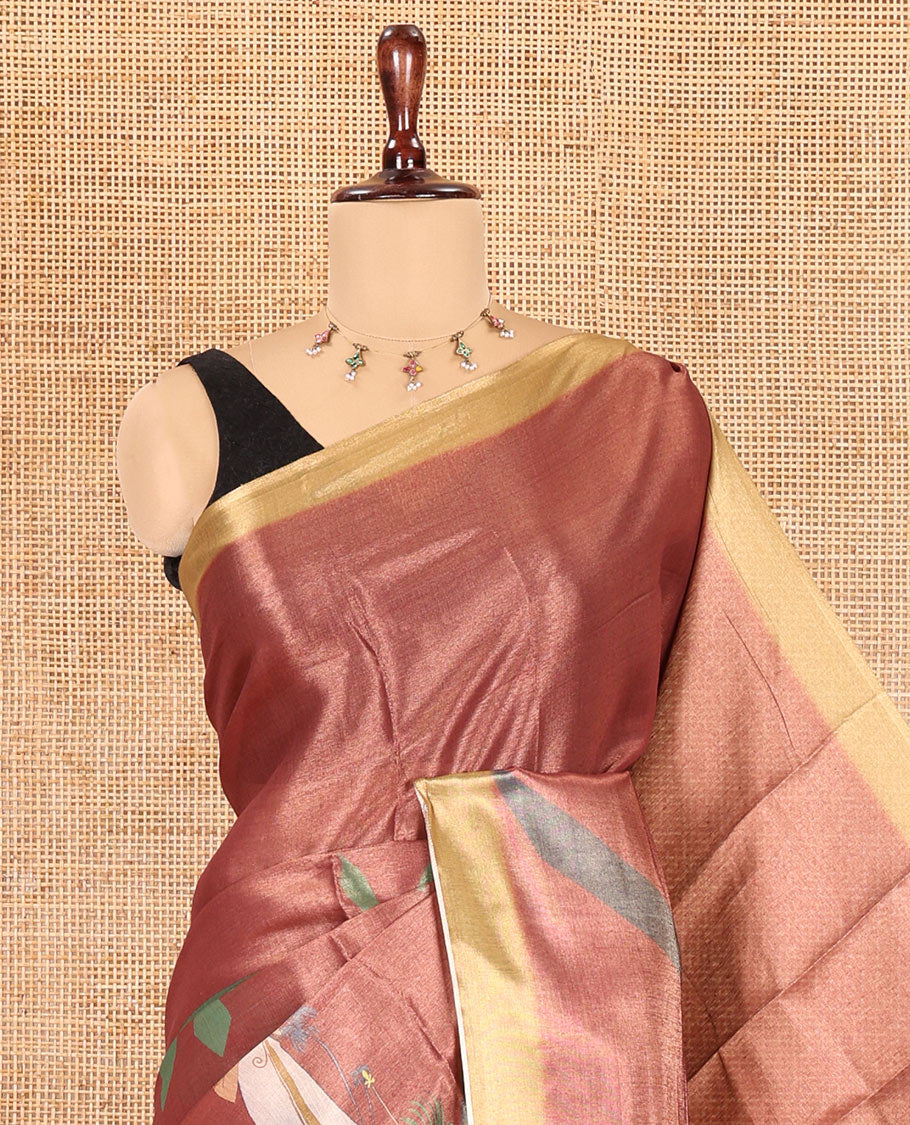 Reddish-Brown Kerala Culture-Themed Tissue Saree Features a Girl, Banana Leaf, and Kolam Motifs, Contrast Border, and Blouse