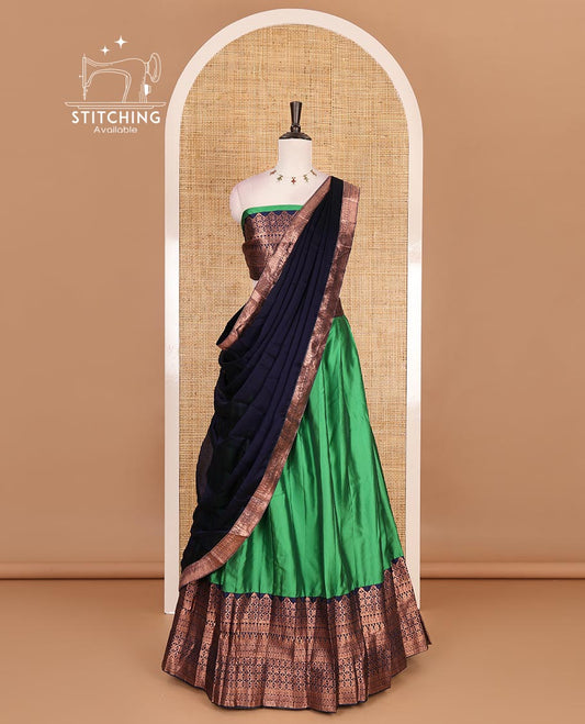 Green taffeta silk half saree, plain with contrast navy blue traditional zari big border, matching zari blouse, and contrast plain zari border dhavani