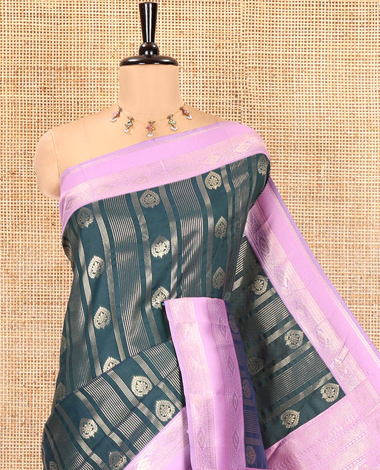 Bottle Green Litchi Saree, Elevated with Vaira Oosi Stripes and Zari Buttas on Its Body, Complemented by a Contrast Rettai Pettu Traditional Zari Design Border, an Intricately Designed Pallu, and Paired with a Contrast Blouse