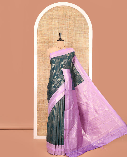 Bottle Green Litchi Saree, Elevated with Vaira Oosi Stripes and Zari Buttas on Its Body, Complemented by a Contrast Rettai Pettu Traditional Zari Design Border, an Intricately Designed Pallu, and Paired with a Contrast Blouse