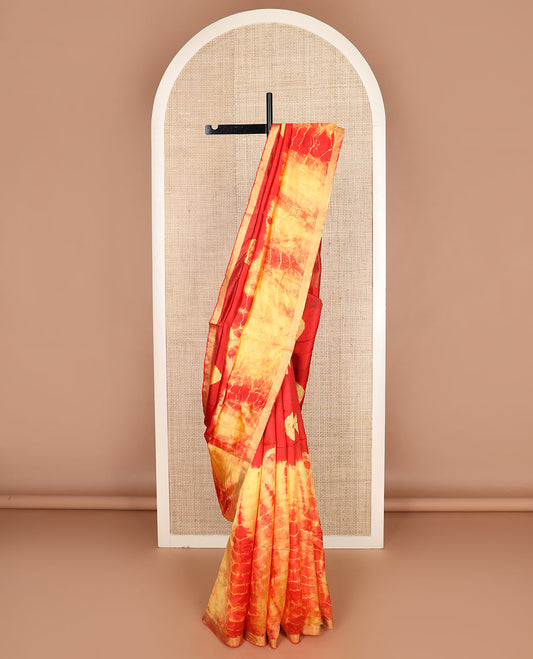 Red and yellow shibori printed banana pith saree, zari piping border, and zari striped pallu