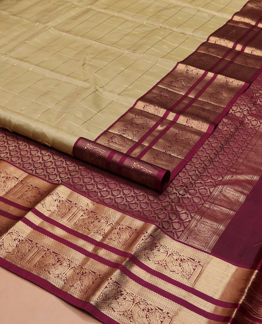 Light gold zari buttas and checked silk saree, contrast border of banaras, mayil kann, and mayil designs, and zari-rich jaal pallu
