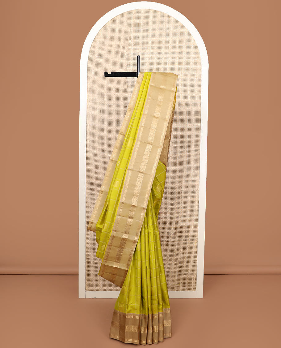 Green zari butta enclosed checked silk saree, contrast border of mayil chakram and muthu stripes, and jaal pallu