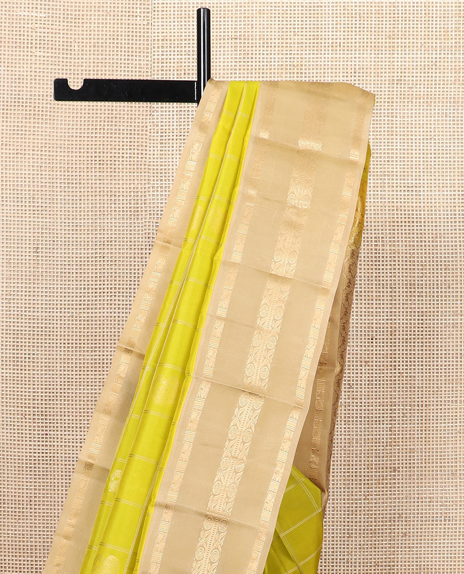 Green zari butta enclosed checked silk saree, contrast border of mayil chakram and muthu stripes, and jaal pallu