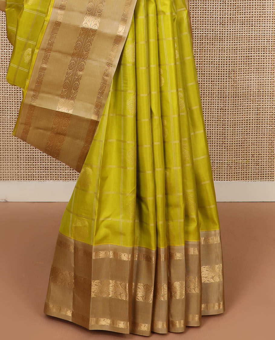 Green zari butta enclosed checked silk saree, contrast border of mayil chakram and muthu stripes, and jaal pallu