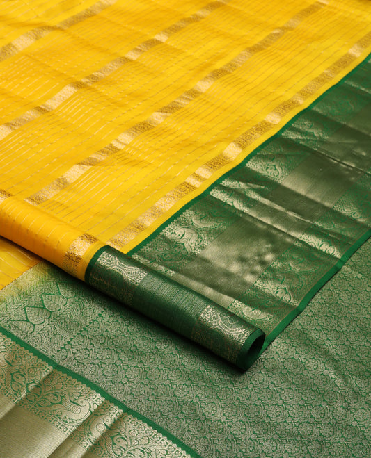 Yellow zari design silk saree, contrast border of reeku, lavangam, and kili designs, and  ogee patterned pallu