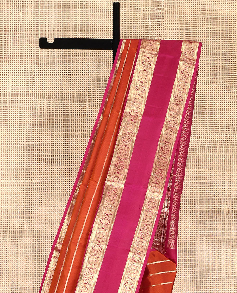 Orange Vasundhara Silk Saree, Richly Detailed with Zari Stripes All Over Its Body, Complemented by Contrast Rettai Pettu Border of  Manga, Muthu, Diamond and Chakram Designs, Intricately Zari Detailed Pallu, and Paired with a Contrast Blouse