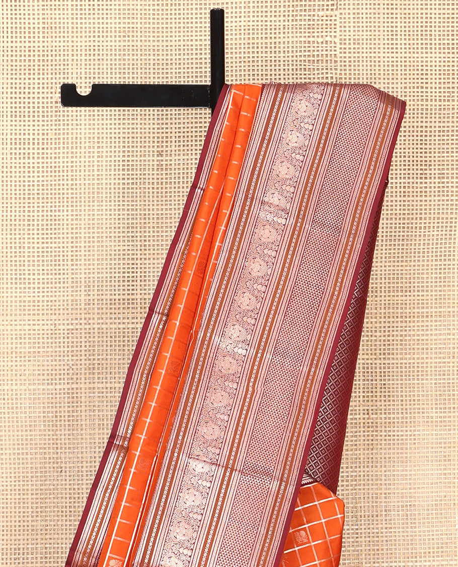 Orange Vasundhara Silk Saree, Meticulously Crafted with Zari Butta Enclosed Checks, Complemented by Contrast Border of Thilakam Mokku, Rettai Neli, Iruthalai Pakshi, and Ara Maadam Designs, Grand Jaal Pallu and Paired with a Contrast Blouse