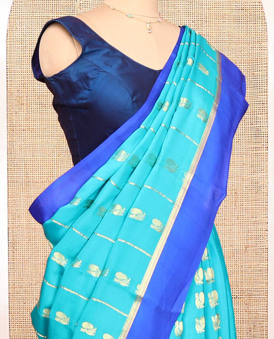 Blue Mysore Silk Saree, Adorned With Zari Stripes and Peacock Buttas Across Its Body, Complemented by Captivating Contrast Border of Traditional Zari Designs, Pallu Steeped with Traditional Zari Designs, and Paired with a Contrast Blouse