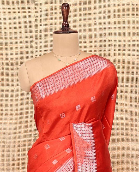 Orange Banana Pith Saree, Mesmerized with Buttas All Over Its Body, Highlighted by Self-Border of Temple and Rudraksham Motifs, Pallu Steeped with Stripes and Buttas, and Paired with a Matching Blouse