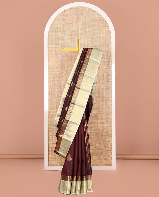 Maroon Vasundhara Silk Saree, Enthralled with Zari Buttas and Zari Design All Over Its Body, Complemented by a Contrast Border of Traditional Designs, Sparsely Sparkled Pallu of Thilakam Designs, and Paired with a Contrast Blouse