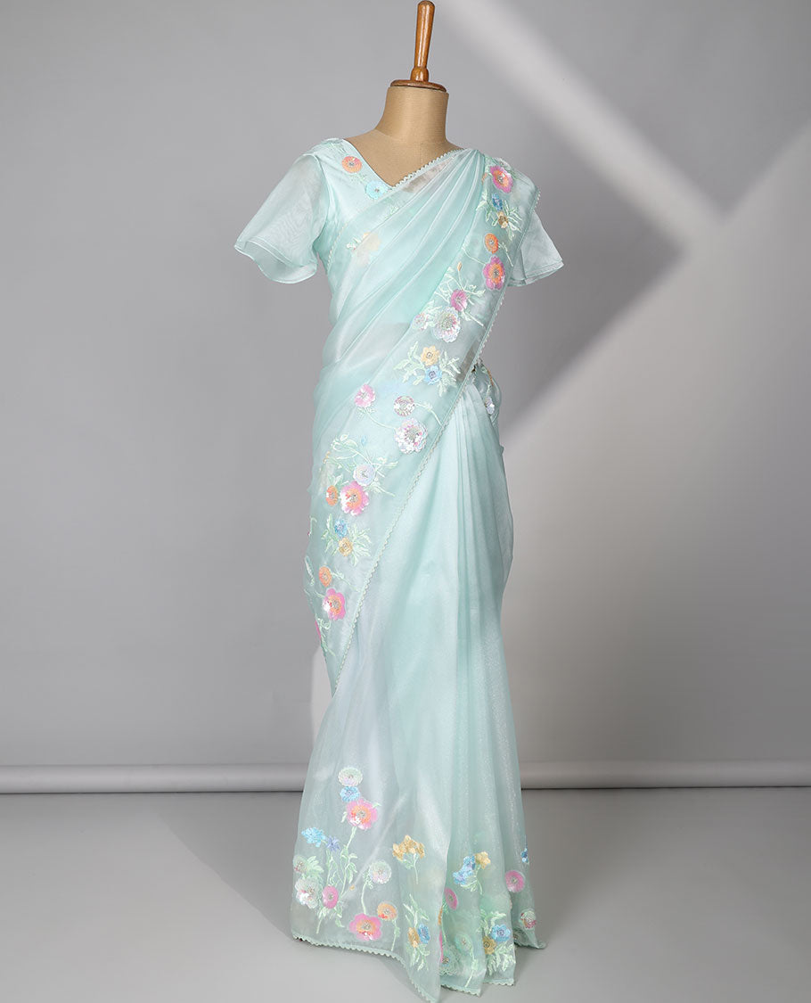 Pale green plain designer catalog saree, scallop border adorned with colorful floral vine embroidery