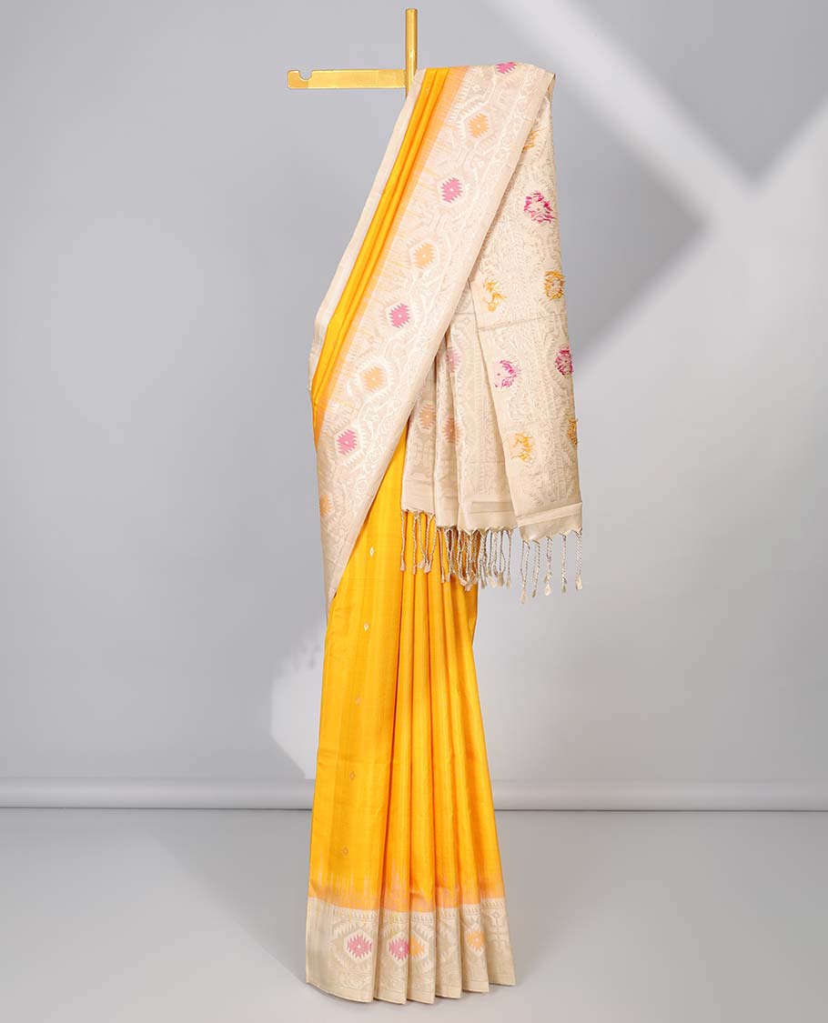Orange soft silk saree with buttas, contrast border & pallu of patola-style meenakari designs