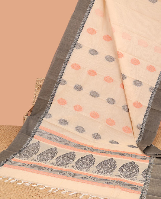 Cream kanchi cotton saree with buttas, contrast plain border & intricate design pallu 
