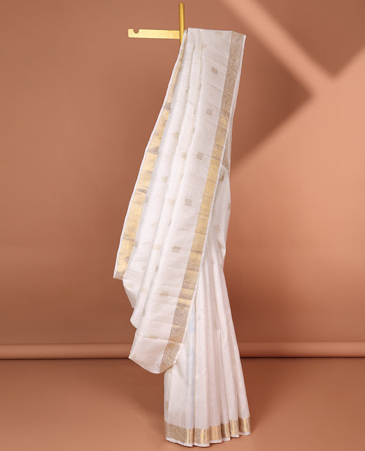 Cream embossed silk saree with zari buttas, kodi visiry zari border & jaal pallu