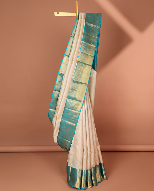 Cream embossed silk saree, contrast zari border of traditional designs & jaal pallu