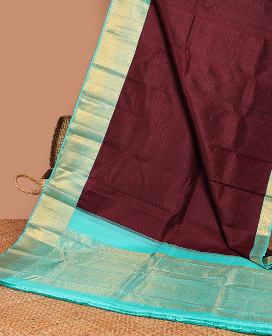 Maroon embossed silk saree, contrast zari border & pallu of traditional designs
