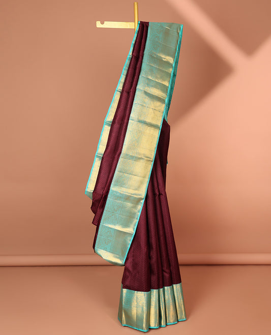 Maroon embossed silk saree, contrast zari border & pallu of traditional designs