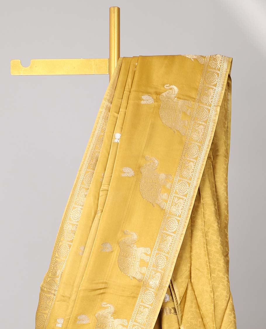 Mustard mushru silk saree with buttas, peacock & chakram border & floral creeper pallu
