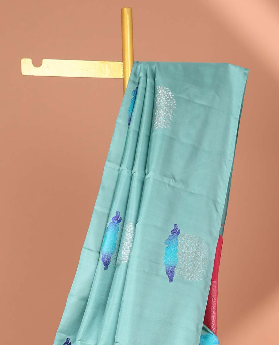 Borderless blue Kanchipuram silksaree with buttas, contrast pallu of floral, paisleys, chakram, and neli designs