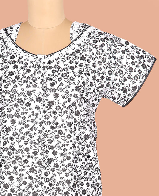 White Cotton Nighty Adorned with Floral Motifs Print, Featuring Neck Lace Work, Unique Front Neck, and Half Sleeves