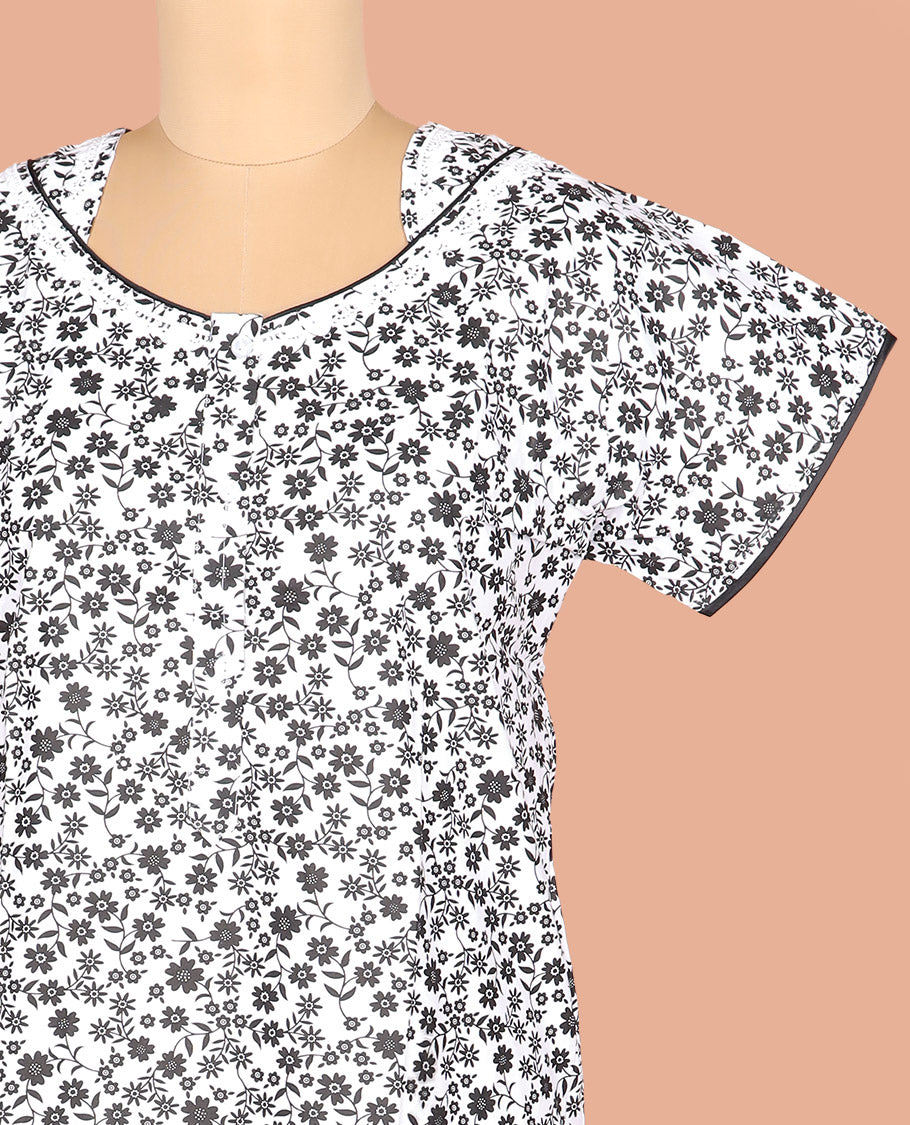 White Cotton Nighty Adorned with Floral Motifs Print, Featuring Neck Lace Work, Unique Front Neck, and Half Sleeves