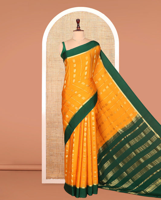 Orange Mysore Silk Saree, Embellished with Peacock Buttas and Stripes Across Its Body, Complemented by Contrast Border, Pallu Steeped with Traditional Zari Designs, and Paired with a Contrast Blouse
