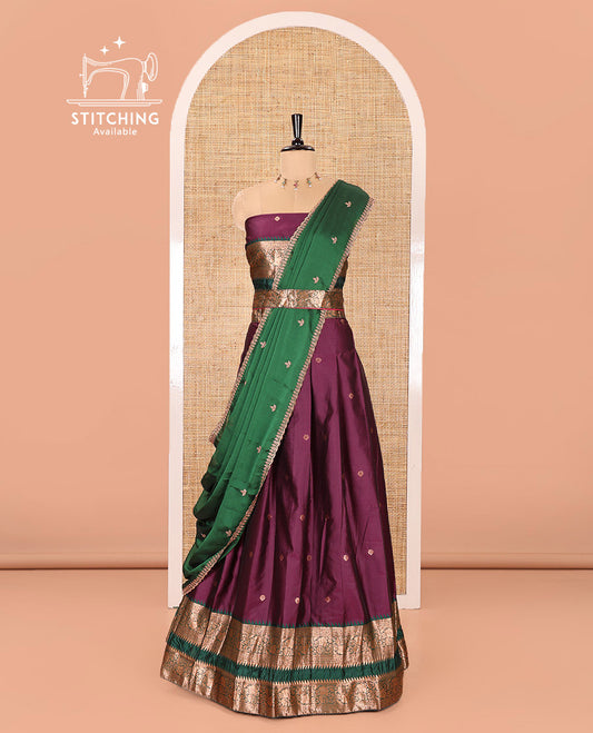 Purple-Green Semi-Banarasi Half-Saree Featuring Zari Buttas on Its Skirt, Complemented by a Contrast Traditional Zari Temple Rettai Pettu Border, Paired with a Matching Blouse, and a Satin Georgette Embroidered Scallop Dhavani
