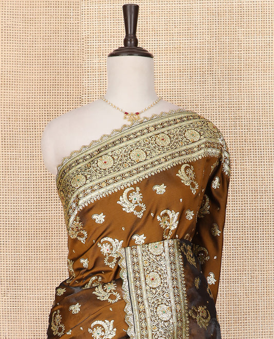 Brown Art Vastrakala Silk Saree Graced with Zari Buttas with Stone Work All Over Its Body, Complemented by a Floral Creeper Zari Stone Work Lace Border, Mughal-Style Pallu Detailed in Zari and Stone Work, and Paired with a Matching Blouse