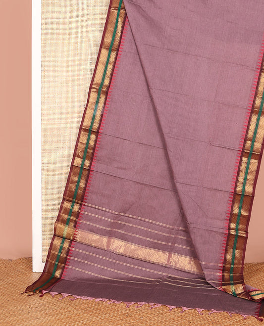 Brown Plain Chettinad Cotton Saree, Complemented by a Contrast Traditional Motifs Woven Zari Rettai Pettu Temple Border, and Gleaming Zari Striped Pallu