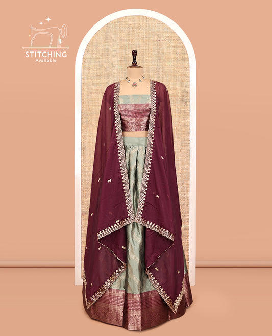 Green Banarasi Half-Saree, Embellished with Jacquard Design, a Contrast Traditional Zari Border, a Matching Blouse, and a Contrast Embroidered Dhavani