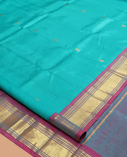 Blue Kanchipuram Silk Saree, Ornamented with Zari Buttas, a Contrast One-Sided Border of Paneer Sombu, Banaras, Muthu and Jaal Design, Zari Design Pallu, and No Blouse