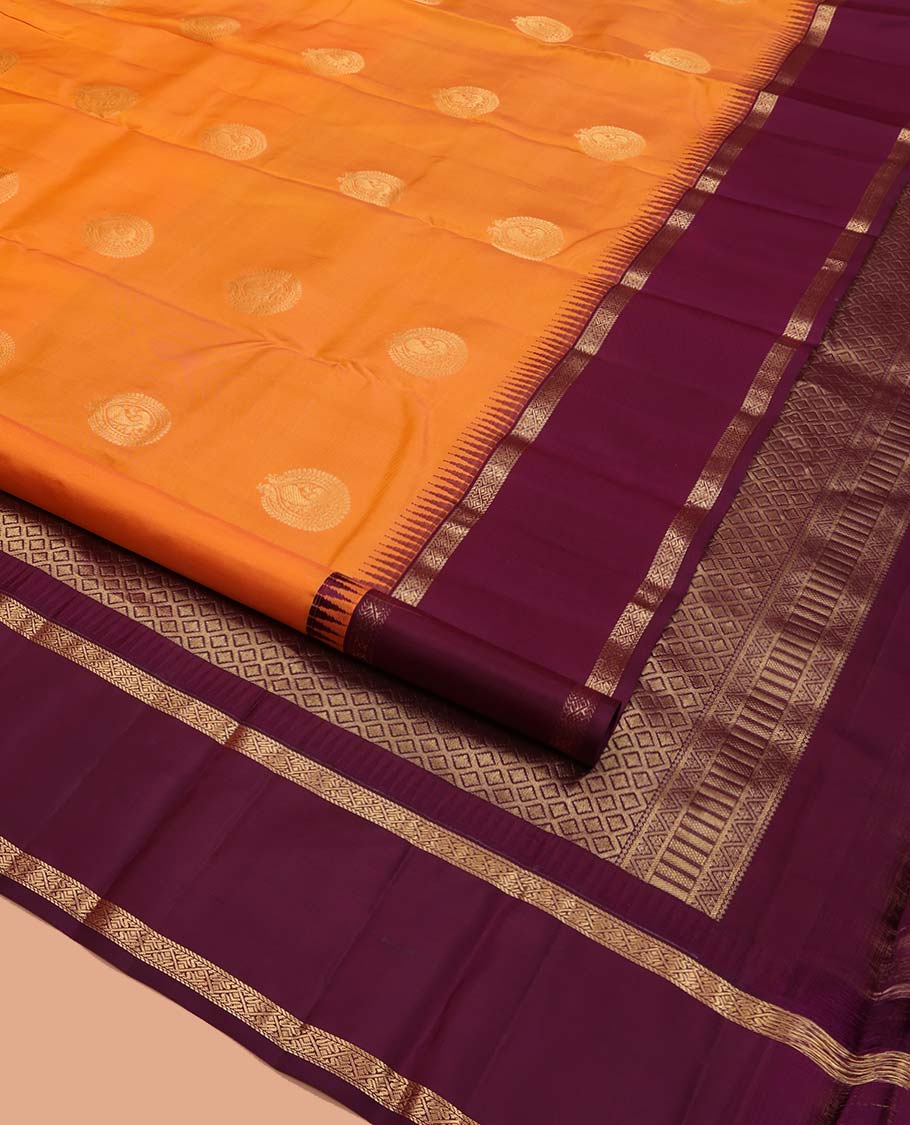 Orange Vasundhara Silk Saree, Delicately Woven with Zari Buttas All Over Its Body, Complemented by a Contrast Rettai Pettu Temple Border of Zari Designs, Grand Jaal Pallu, and Paired with a Contrast Blouse