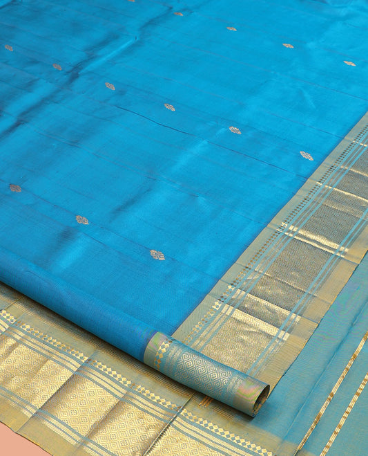 Blue Kanchipuram Silk Saree, Gleamed Up with Zari Buttas, a Contrast One-Sided Border of Panner Sombu, Banaras, and Jaal Designs, a Zari Design Pallu, and No Blouse